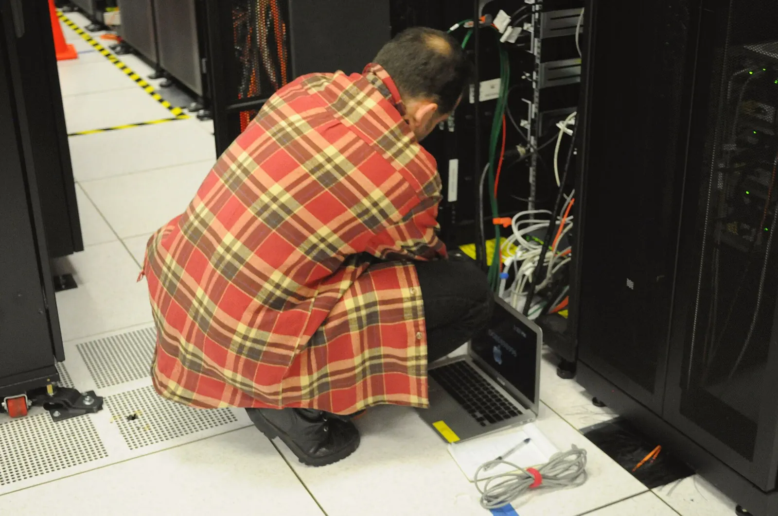 A technician working on a server rack at the NERSC computing centre, Berkeley, California